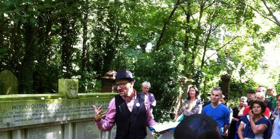 Hackney Tours talking to group by Coronation Avenue marker